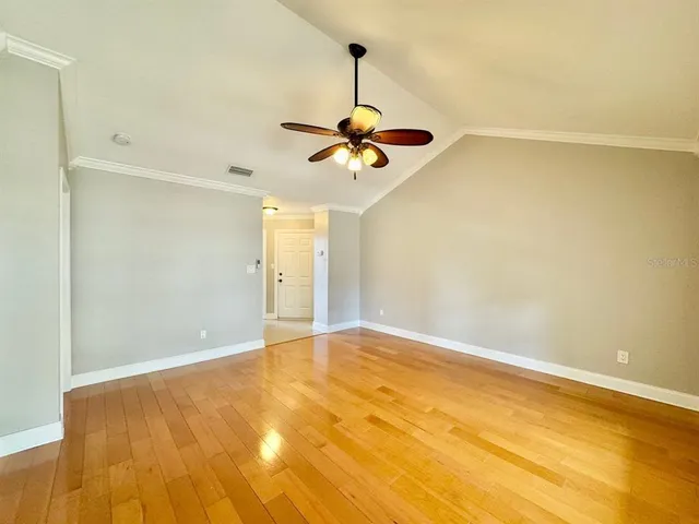 a view of empty room with a ceiling fan
