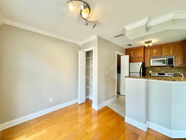 a kitchen with stainless steel appliances granite countertop a refrigerator a stove and a sink