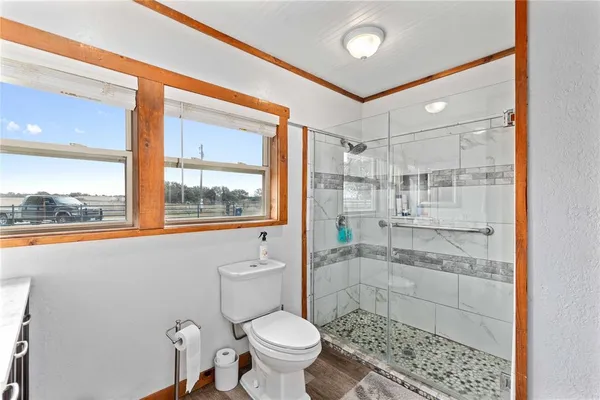 a bathroom with a toilet and a shower