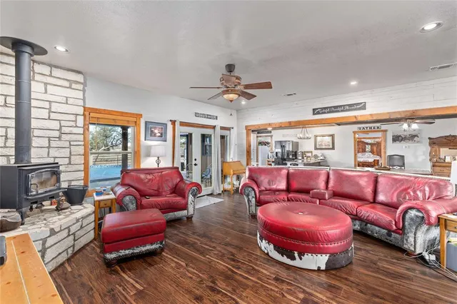 a living room with furniture a fireplace and a table