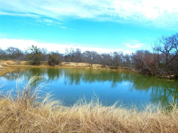 a view of swimming pool with an outdoor seating and a yard