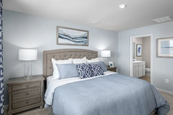 a bedroom with a bed and a painting on the wall