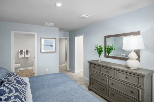 a bedroom with a bed and a dresser in it