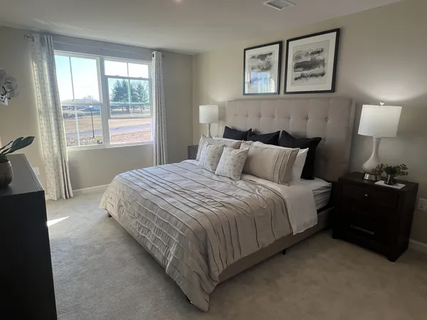 a bedroom with a bed and a lamp