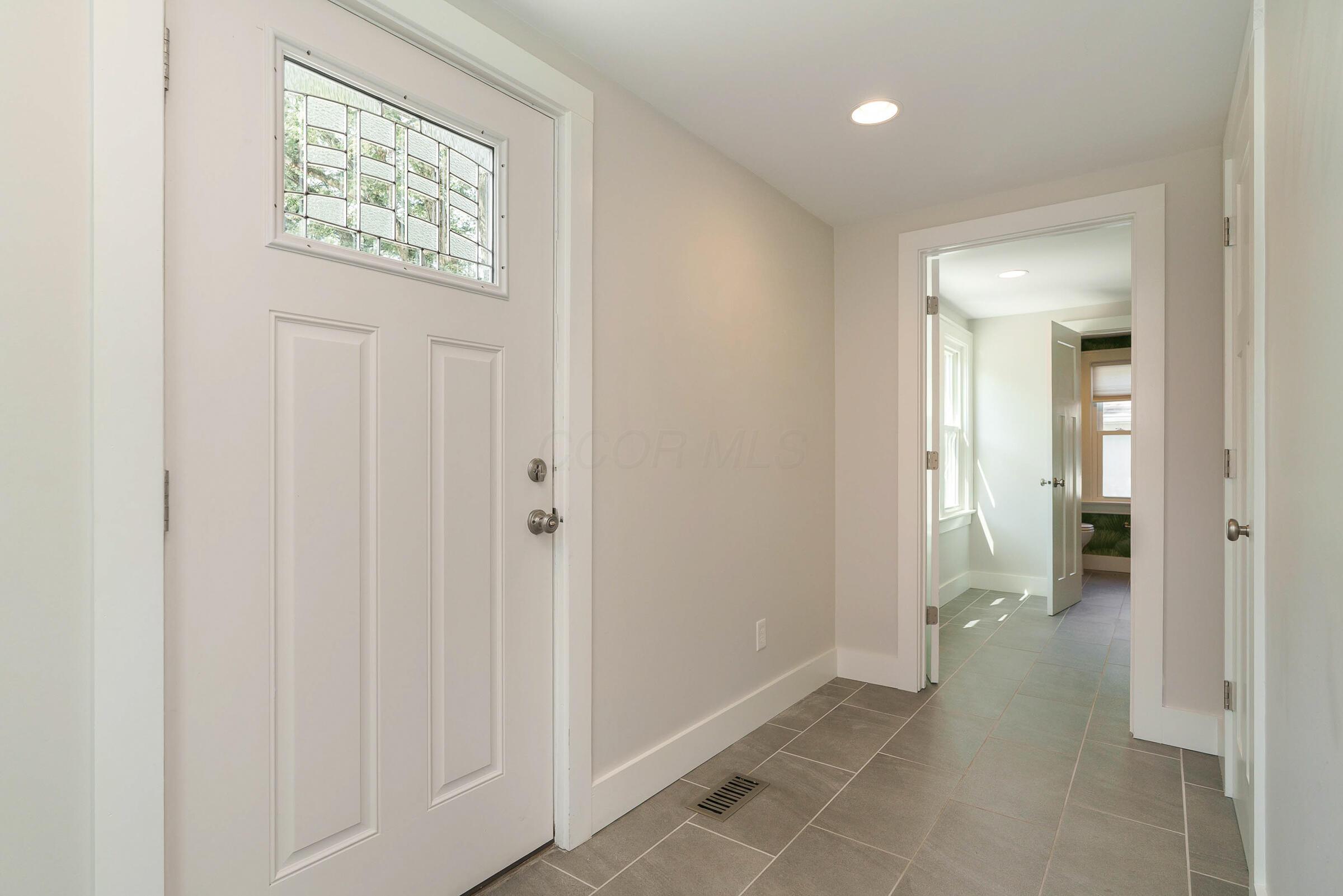163 Garden Road Columbus, OH 43214 - Photo 20 of 46 Back door opens into a generous tiled mudroom, leading to the entry level laundry room.