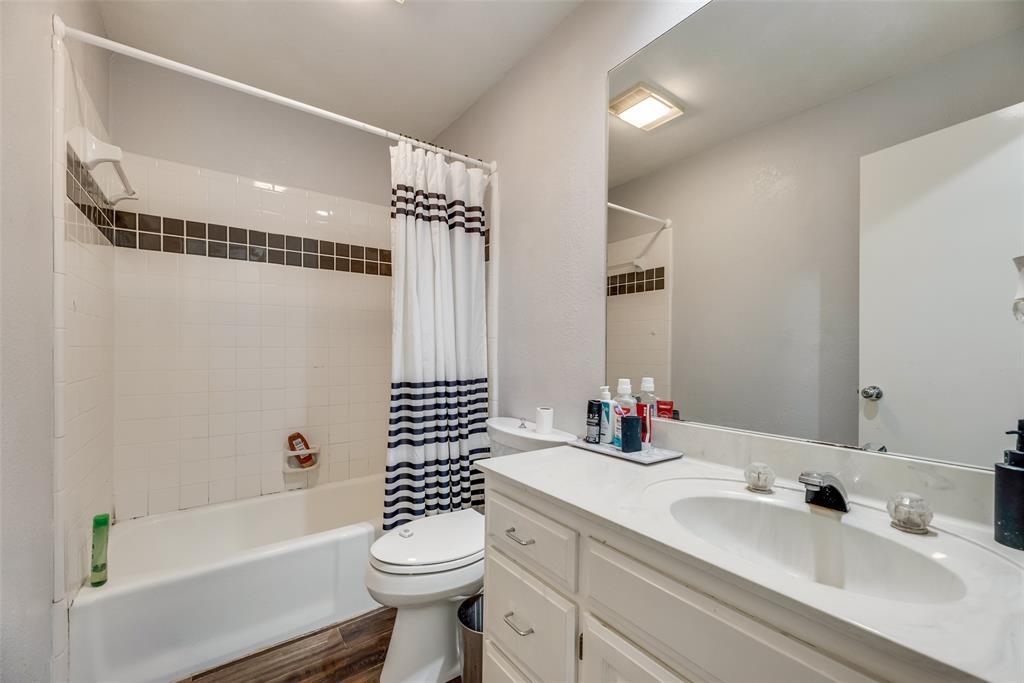 4102 Autumn Ridge Court Arlington, TX 76016 - Photo 12 of 20 Bathroom with shower / bathtub combination with curtain, vanity, and dark wood-style floors