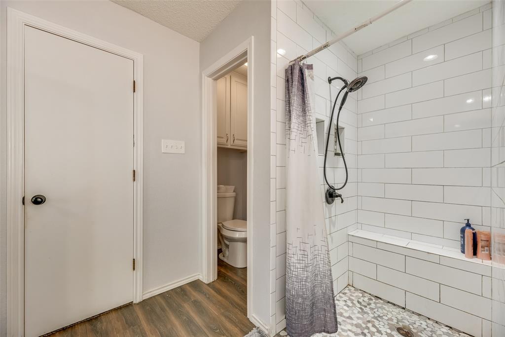 4102 Autumn Ridge Court Arlington, TX 76016 - Photo 15 of 20 Full bath with a stall shower and dark wood-style floors