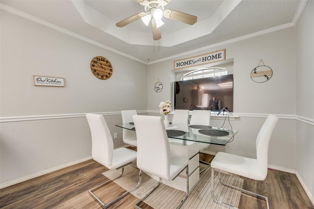 4102 Autumn Ridge Court Arlington, TX 76016 - Photo 5 of 20 Dining area featuring a tray ceiling, ornamental molding, a ceiling fan, and wood finished floors