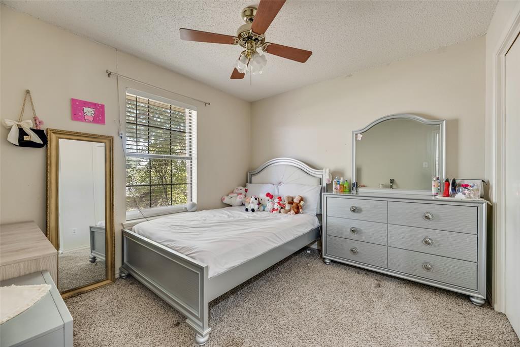 4102 Autumn Ridge Court Arlington, TX 76016 - Photo 10 of 20 Bedroom featuring light colored carpet, a textured ceiling, and ceiling fan