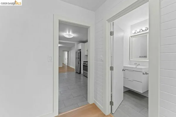 a view of a hallway with closet and a bathroom