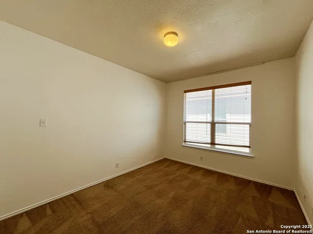 an empty room with a empty space and window