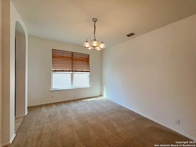 a view of an empty room with a ceiling fan
