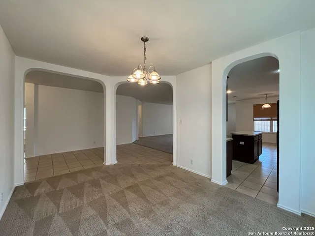 a large kitchen with a counter space a sink and cabinets