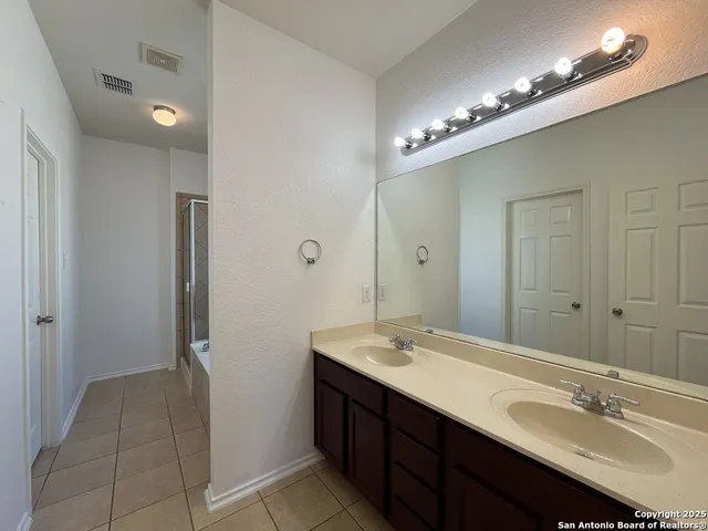 an empty room with a ceiling fan and window