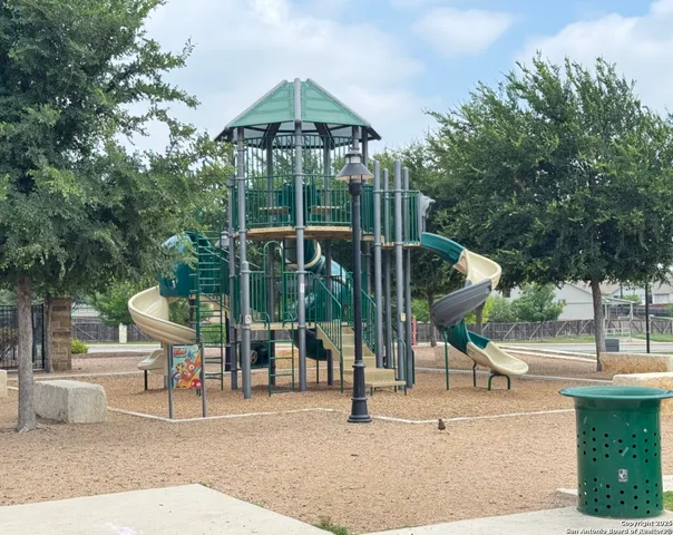 an aerial view of a house with a yard and furniture