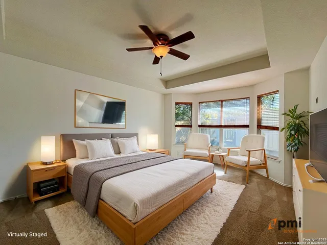 a bedroom with a large bed and a large window