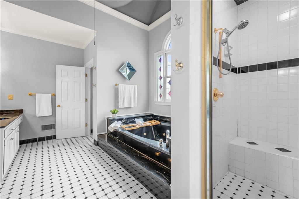 1696 Harts Run Atlanta, GA 30341 - Photo 31 of 55 a bathroom with a bathtub and a shower