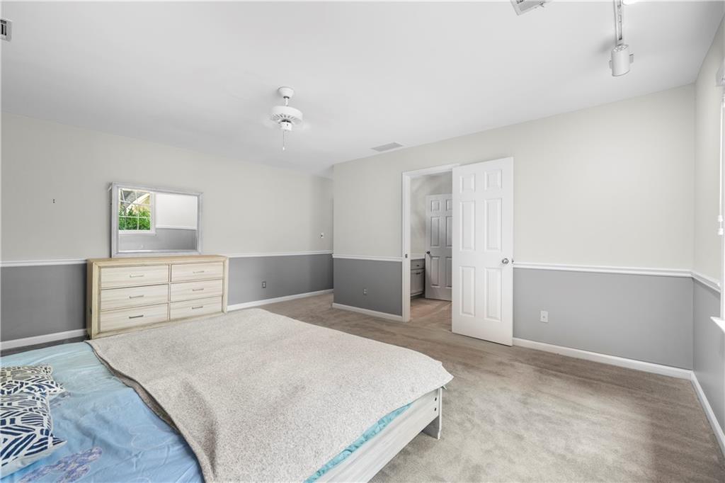 1696 Harts Run Atlanta, GA 30341 - Photo 44 of 55 a spacious bedroom with a bed and a cabinets