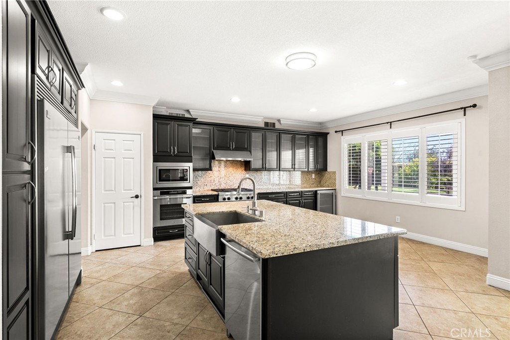 5105 Sanchez Court Rancho Cucamonga, CA 91739 - Photo 14 of 61 a kitchen with stainless steel appliances granite countertop a refrigerator and a stove top oven