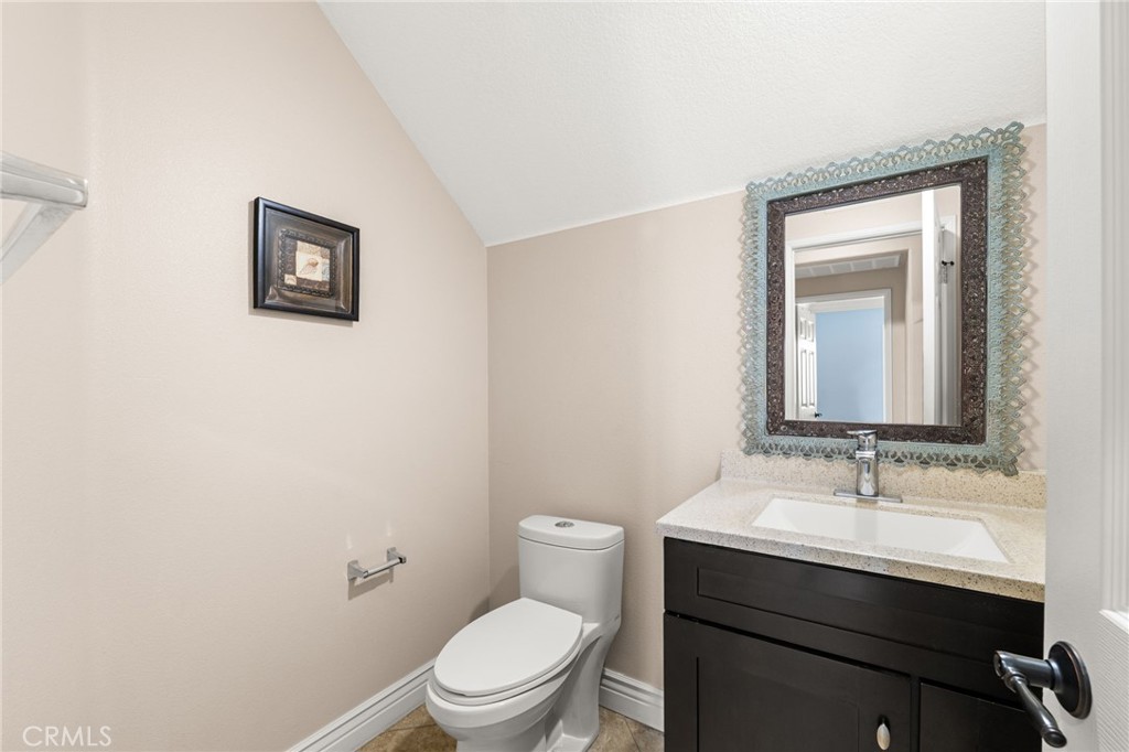 5105 Sanchez Court Rancho Cucamonga, CA 91739 - Photo 17 of 61 a bathroom with a toilet a sink and mirror