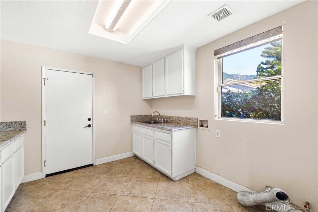 5105 Sanchez Court Rancho Cucamonga, CA 91739 - Photo 18 of 61 a kitchen with granite countertop a stove a sink and a refrigerator