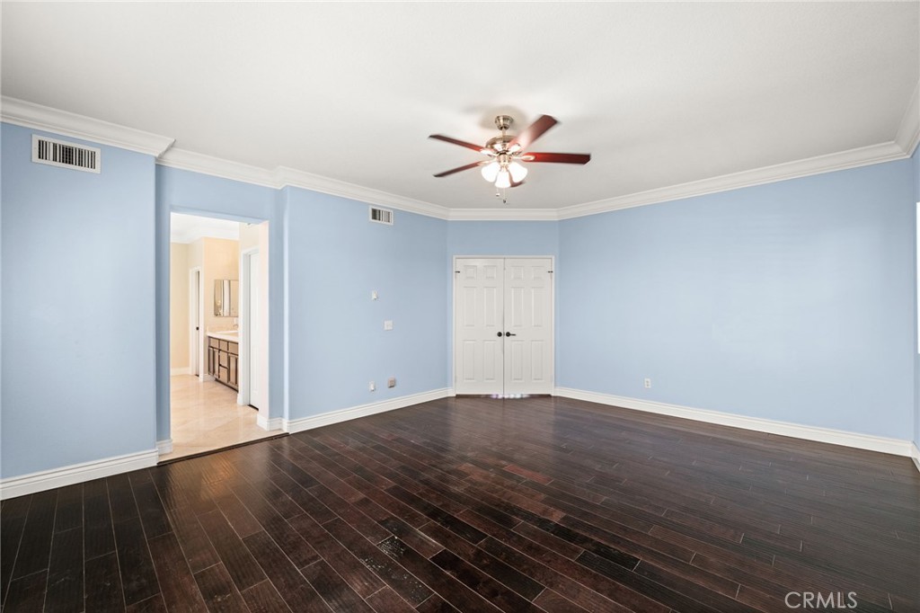 5105 Sanchez Court Rancho Cucamonga, CA 91739 - Photo 26 of 61 a view of an empty room with wooden floor and a ceiling fan