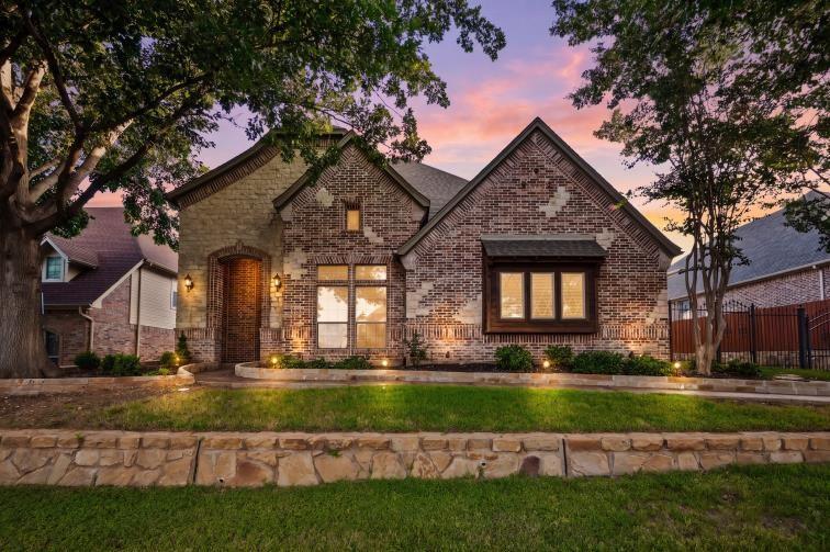 620 Highview Lane Hurst, TX 76054 - Photo 2 of 40 Brick and stone facade residence featuring an arched entryway, multiple gables, and a window box with dark trim