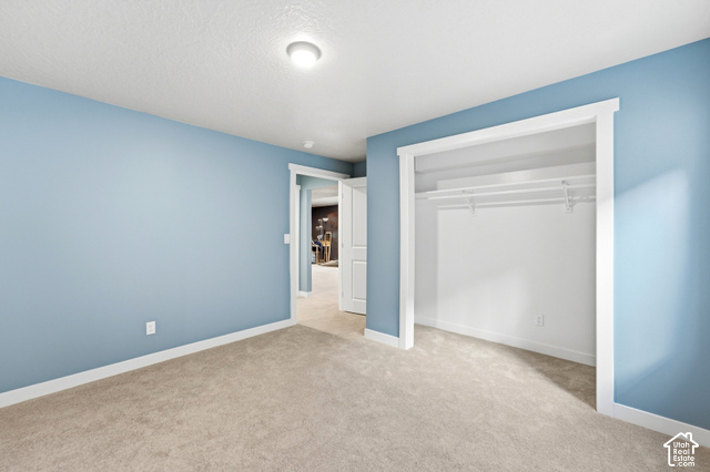 986 South Old Farm Road Heber City, UT 84032 - Photo 39 of 51 Plush carpet flooring, light blue wall finishes, white trim, and a built-in closet with shelving and hanging rods