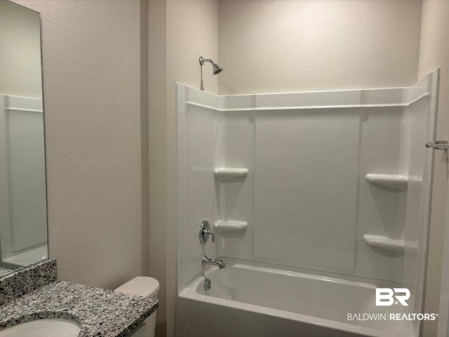 16810 Rocher Court Foley, AL 36535 - Photo 17 of 24 Bathroom featuring a white tub/shower combination with chrome fixtures, a speckled countertop, and a built-in vanity mirror