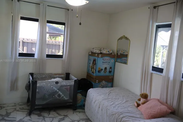 a bedroom with bed and a window