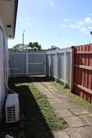 a bedroom with a bed and a flat tv screen on wall