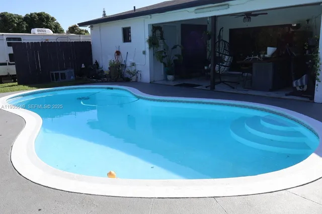a view of a swimming pool with an outdoor seating
