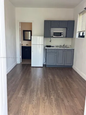 a view of a hallway with wooden floor and closet
