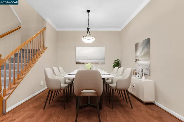 a view of a room with wooden floor and white walls