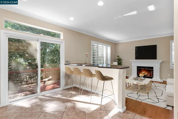 a kitchen with granite countertop white cabinets and stainless steel appliances