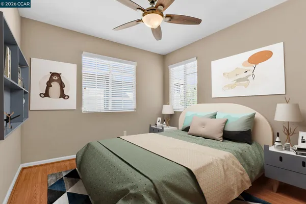 an empty room with windows and fan