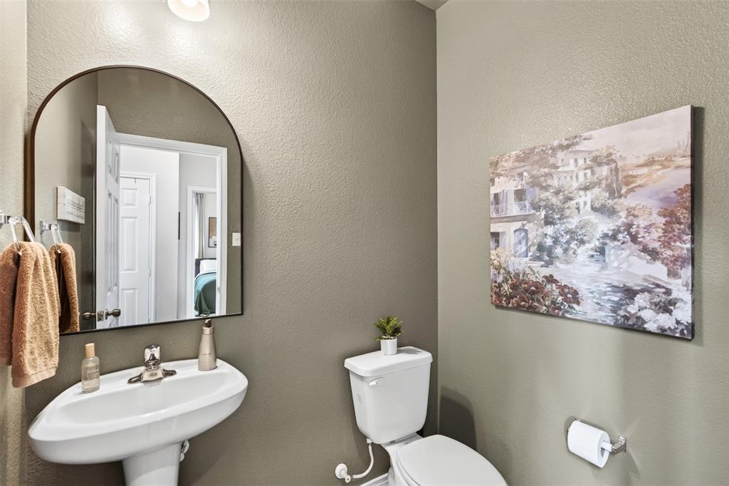 3105 Marston Road Lorena, TX 76655 - Photo 20 of 40 Pedestal sink with chrome faucet, complemented by an arched mirror
