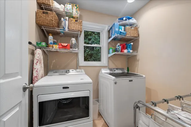 a bedroom with a bed a couch and dresser