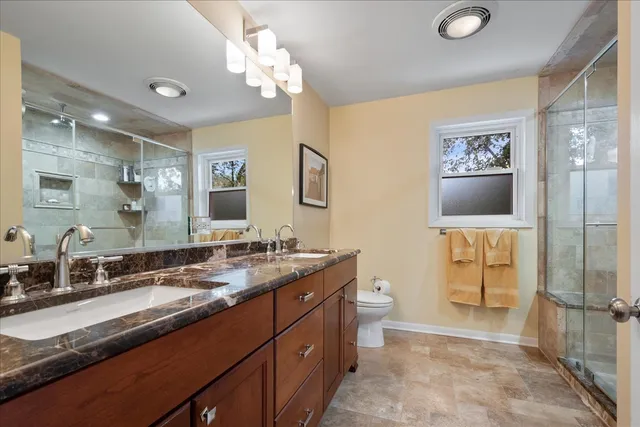 a bathroom with a granite countertop shower mirror and a sink
