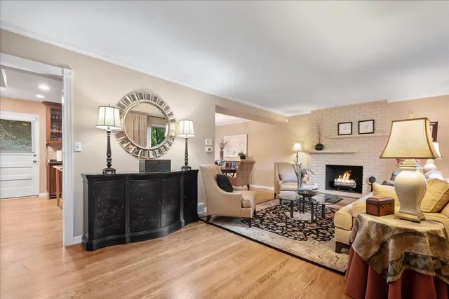 a living room with furniture a fireplace and a table