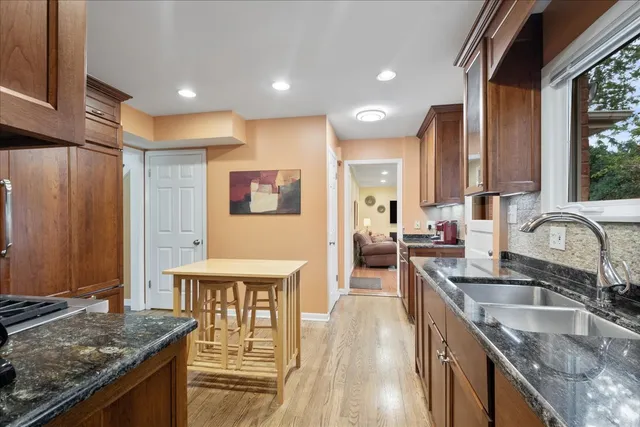 a kitchen with stainless steel appliances granite countertop a sink stove and cabinets