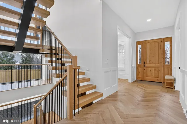a kitchen with granite countertop a stove a sink a center island and wooden floor