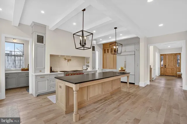 a kitchen with stainless steel appliances granite countertop a stove and a wooden floors