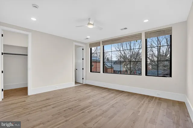 a view of a hallway with wooden floor and entryway
