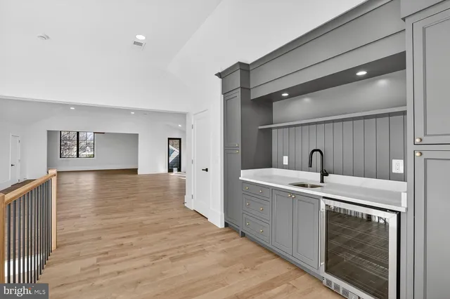 a view of empty room with wooden floor and windows