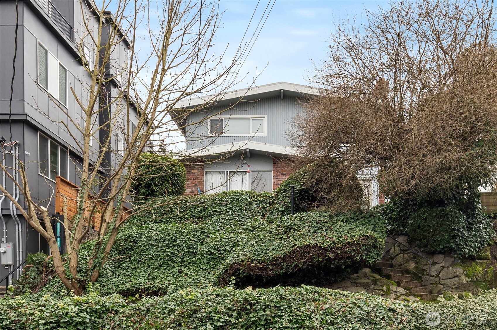 633 West Emerson Street Seattle, WA 98119 - Photo 5 of 25 a view of a house with a yard and large trees
