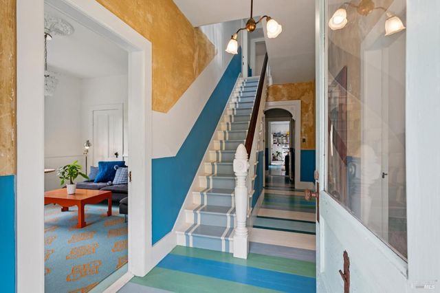 a bed room with a bed table and a window