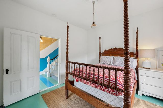 a bedroom with a bed a desk and chair