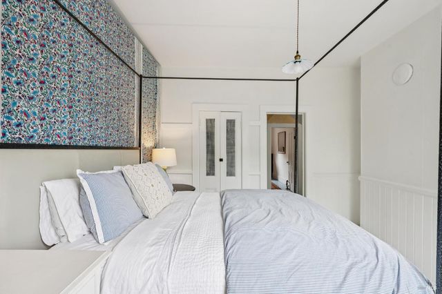 a bedroom with two beds and a table