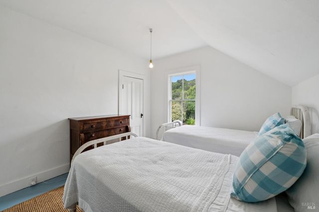 a view of a backyard with table and chairs potted plants and wooden fence